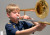 A Year 4 student plays a trombone during a small group lesson with an instrumental tutor as part of the Year 4 Band Program